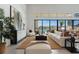 Bright living room with floor-to-ceiling windows and a view of the outdoor pool area; offers natural light and views at 144 Tre Pietre St, Henderson, NV 89011