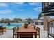 Expansive outdoor dining area with a large table, chairs, pool, and BBQ, perfect for hosting gatherings and enjoying the outdoors at 144 Tre Pietre St, Henderson, NV 89011