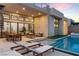 Expansive outdoor patio area with a pool, dining, and seating ideal for entertaining, all under a covered space at 144 Tre Pietre St, Henderson, NV 89011