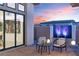 Outdoor patio featuring a sleek water feature, ambient lighting, and modern furniture against a scenic sunset at 144 Tre Pietre St, Henderson, NV 89011