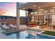 Beautiful backyard featuring a pool, outdoor dining, comfortable seating, and spiral staircase for an elegant living space at 144 Tre Pietre St, Henderson, NV 89011