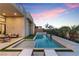 Tranquil backyard oasis with a modern pool, lounge chairs, and lush landscaping creating a private retreat at 144 Tre Pietre St, Henderson, NV 89011