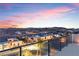 Breathtaking rooftop deck view of the surrounding neighborhood, mountains, and a serene lake at sunset at 144 Tre Pietre St, Henderson, NV 89011