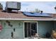 Backyard view of the home showcasing solar panels, a patio, and an external air conditioning unit at 1812 Ivanhoe Way, Las Vegas, NV 89102