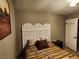 A cozy bedroom featuring a queen bed, a modern headboard, and warm lighting at 1812 Ivanhoe Way, Las Vegas, NV 89102