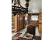 A dining room featuring a decorative chandelier, wood cabinets, and a stainless steel refrigerator at 1812 Ivanhoe Way, Las Vegas, NV 89102