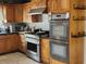 A kitchen featuring stainless steel appliances, including a gas range, oven, and wooden cabinets at 1812 Ivanhoe Way, Las Vegas, NV 89102