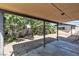 Backyard featuring mature trees, a concrete patio, and a storage shed at 2204 Monterey Ave, Las Vegas, NV 89104