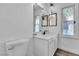Bathroom featuring toilet, vanity, framed mirrors, and decorative lighting at 2204 Monterey Ave, Las Vegas, NV 89104