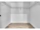 Walk-in closet with hanging rods and wood-look floors at 2204 Monterey Ave, Las Vegas, NV 89104