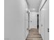 Long hallway with hardwood floors and multiple storage closets at 2204 Monterey Ave, Las Vegas, NV 89104