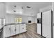 A spacious kitchen with white cabinets and granite countertops connects to the living room at 2204 Monterey Ave, Las Vegas, NV 89104