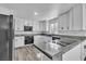 The modernized kitchen features granite countertops, sleek black appliances, and all-white cabinetry at 2204 Monterey Ave, Las Vegas, NV 89104
