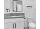 Bathroom features a new white vanity with gray countertop, square mirror, modern fixtures, and white toilet with textured wall panel at 244 N 19Th St, Las Vegas, NV 89101