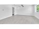 Large primary bedroom with contemporary ceiling fan, neutral paint, new floors and a door leading to the Primary bathroom at 244 N 19Th St, Las Vegas, NV 89101