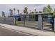Charming home featuring a modern metal gate, gray exterior paint and beautiful desert landscaping with a blue sky backdrop at 244 N 19Th St, Las Vegas, NV 89101