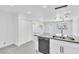 Open-concept kitchen featuring white cabinets, stainless steel appliances, new flooring and a breakfast bar at 244 N 19Th St, Las Vegas, NV 89101