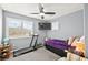 Cozy bedroom with gray walls, a treadmill, and a window with natural lighting at 262 Cielito Lindo St, Henderson, NV 89012