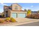 Charming two-story home featuring a tile roof and a two-car garage with eye-catching turquoise doors at 262 Cielito Lindo St, Henderson, NV 89012