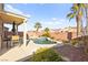 Lush backyard featuring a pool, covered patio with dining, and desert landscaping at 262 Cielito Lindo St, Henderson, NV 89012