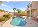 Stunning pool with vibrant blue tile, patio, lush plants, and desert landscaping at 262 Cielito Lindo St, Henderson, NV 89012