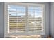 Window with plantation shutters offering a view of the landscaped neighborhood and blue skies at 262 Cielito Lindo St, Henderson, NV 89012