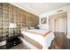 A spacious bedroom featuring a unique padded headboard design and hardwood flooring at 2747 Paradise Rd # 2606, Las Vegas, NV 89109
