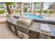 Outdoor stainless steel grill with granite countertops overlooking a beautiful pool at 2747 Paradise Rd # 2606, Las Vegas, NV 89109