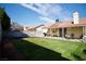 Large backyard with covered patio and green lawn ideal for entertaining and outdoor activities at 2905 Gentilly Ln, Las Vegas, NV 89108