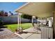 Backyard features a covered patio, manicured lawn, and block wall fencing at 2905 Gentilly Ln, Las Vegas, NV 89108