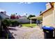 Exterior shot of the backyard featuring covered patio, grass and desert landscaping at 2905 Gentilly Ln, Las Vegas, NV 89108