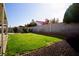 Well-maintained backyard with grass, covered patio, and block wall at 2905 Gentilly Ln, Las Vegas, NV 89108