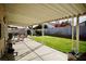 Grassy backyard with covered patio area at 2905 Gentilly Ln, Las Vegas, NV 89108