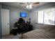 Bedroom features a ceiling fan, desk area with computer, and large window for natural light at 2905 Gentilly Ln, Las Vegas, NV 89108