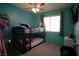 Charming ' bedroom with blue walls, bunk beds, ceiling fan, and a window at 2905 Gentilly Ln, Las Vegas, NV 89108