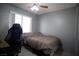 A cozy bedroom with a window seat, ceiling fan, and a comfortable bed at 2905 Gentilly Ln, Las Vegas, NV 89108