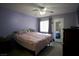 Cozy bedroom with plush bedding, ceiling fan, and access to an ensuite bathroom at 2905 Gentilly Ln, Las Vegas, NV 89108