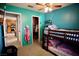 Bright ' bedroom with blue walls, bunk beds, ceiling fan, and closet at 2905 Gentilly Ln, Las Vegas, NV 89108