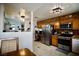Well-equipped kitchen featuring oak cabinets, stainless steel appliances, and a built-in desk area at 2905 Gentilly Ln, Las Vegas, NV 89108