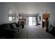 Bright and airy living room featuring a fireplace, a sliding door to the backyard, and open access to the kitchen at 2905 Gentilly Ln, Las Vegas, NV 89108