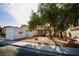 Wide angle street view showcasing the home, landscaping, driveway, and nearby PODS moving container at 2905 Gentilly Ln, Las Vegas, NV 89108