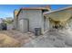 View of the backyard patio with a stone floor, storage shed, and drought-resistant landscaping at 291 Lido Dr, Henderson, NV 89015