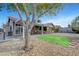 Spacious backyard featuring drought-resistant landscaping, a covered patio and artificial grass at 291 Lido Dr, Henderson, NV 89015