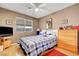 Bedroom featuring a window, fan and dresser with a bed at 291 Lido Dr, Henderson, NV 89015