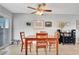 Bright dining room featuring a wooden table, four chairs with decorative cushions, and a ceiling fan at 291 Lido Dr, Henderson, NV 89015
