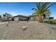 Single-story home with desert landscaping, rock mulch, and a mature palm tree in the front yard at 291 Lido Dr, Henderson, NV 89015