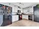 Well-lit kitchen with ample counter space, white cabinets, a black refrigerator, and modern appliances at 291 Lido Dr, Henderson, NV 89015