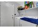 Functional laundry room featuring modern washer, dryer, and ample shelving for storage solutions at 291 Lido Dr, Henderson, NV 89015