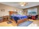 Serene main bedroom with a large wooden bed, ceiling fan, and a window with natural light at 291 Lido Dr, Henderson, NV 89015