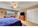 Comfortable main bedroom with a ceiling fan, wooden dresser, and closet with sliding doors at 291 Lido Dr, Henderson, NV 89015